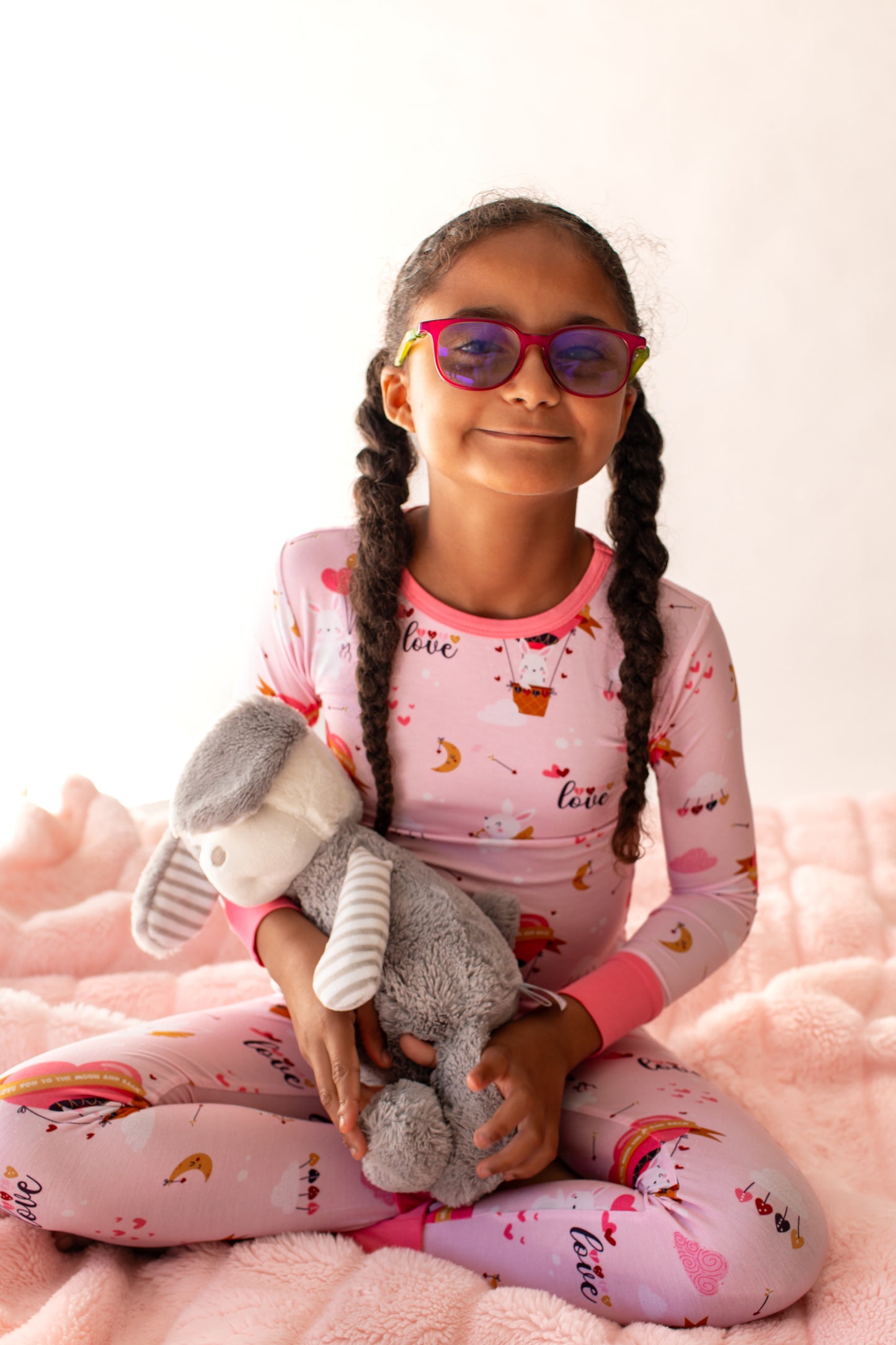 child wearing Pink bamboo kids pajamas featuring Cupid the Bunny