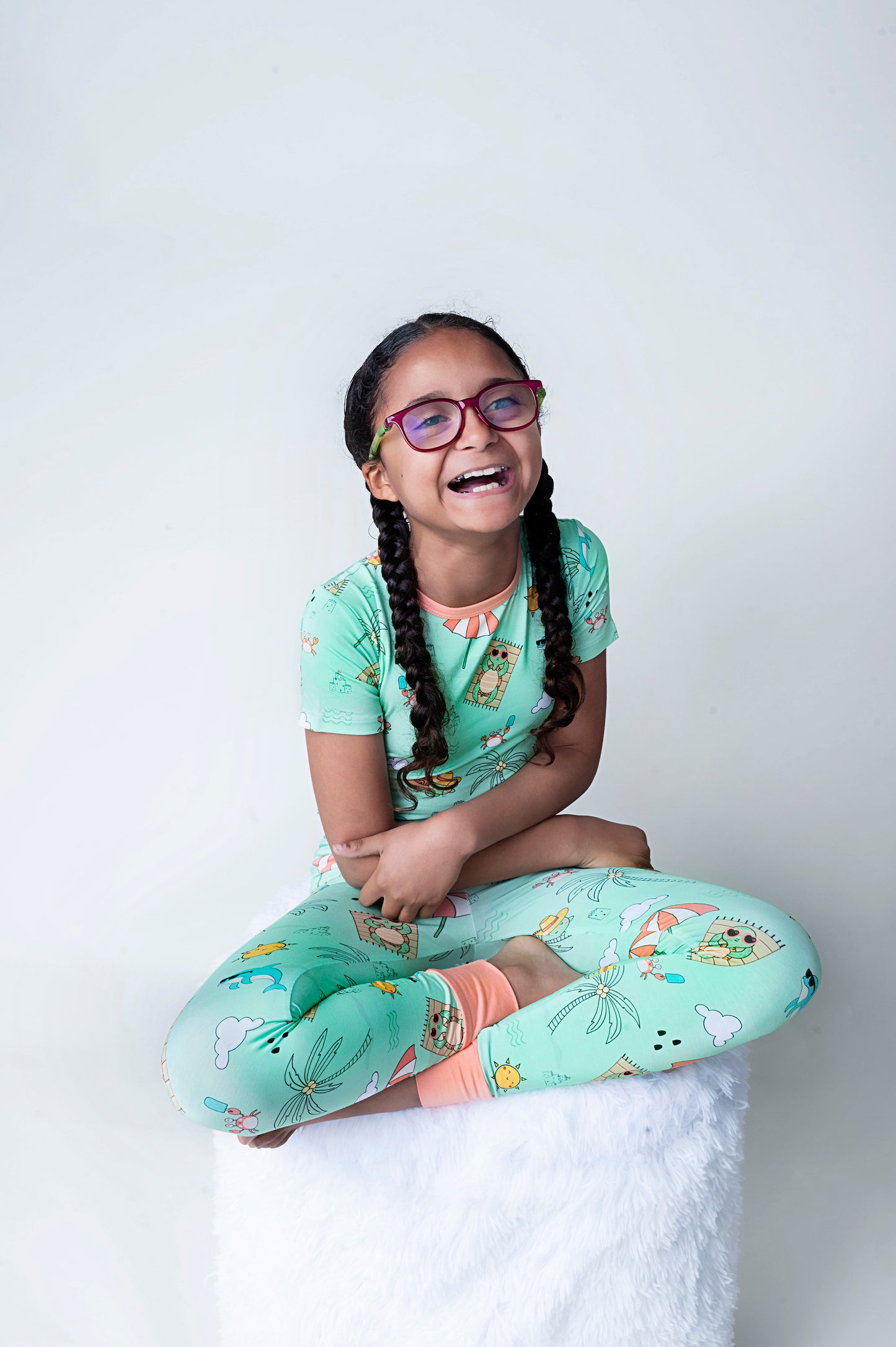 Child wearing Tilly the Tortoise themed print on bamboo kids pajamas