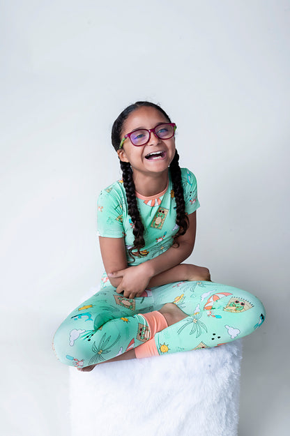 Child wearing Tilly the Tortoise themed print on bamboo kids pajamas