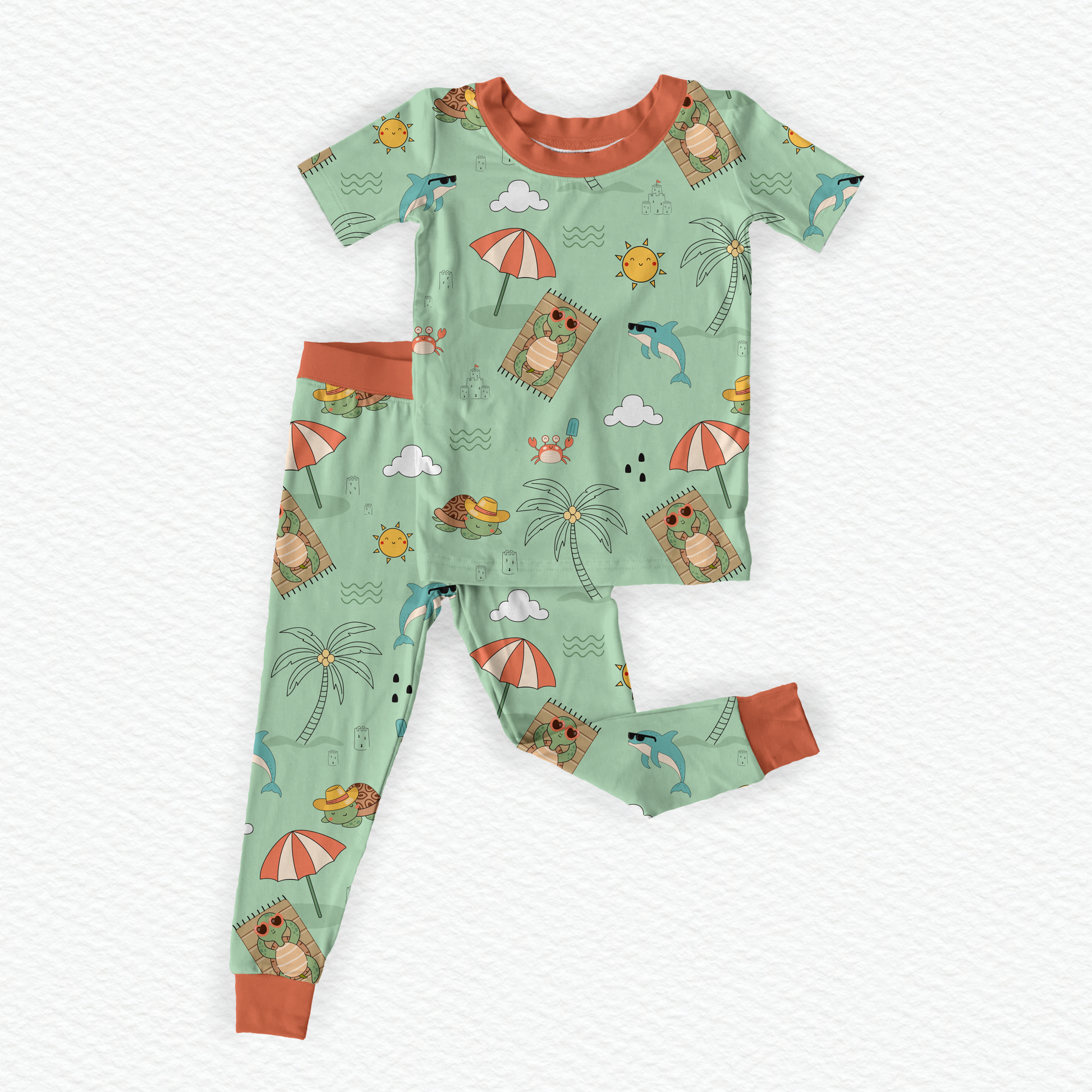 Flat lay Green bamboo kids pajamas featuring Tortoise on the beach with Subtle Braille cues and a tag-free neckline support comfort and ease during everyday routines.