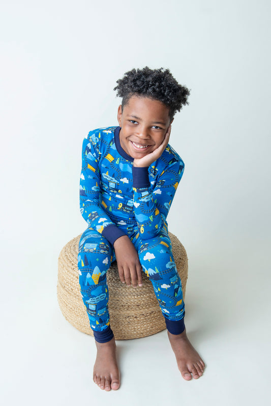 Boy sitting on a cushion wearing Toby bamboo Pajamas