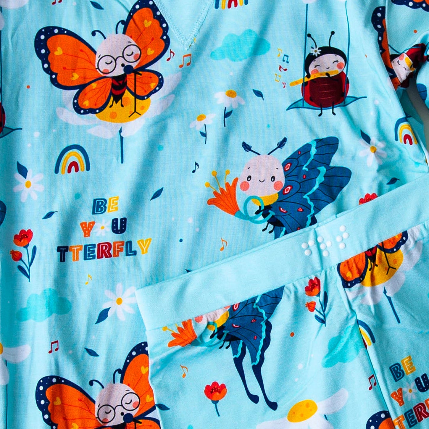 Children's pajama set with animal and butterfly pattern on a white background