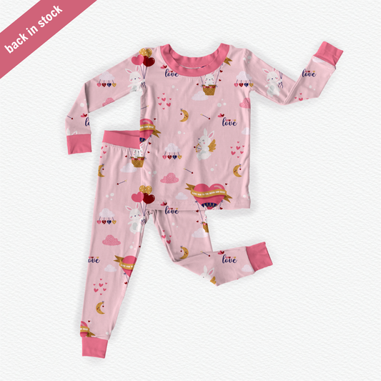 Pink bamboo kids pajamas featuring Cupid the Bunny with braille label