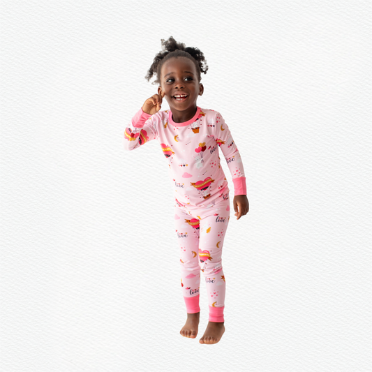 Happy child wearing pink bunny braille pajamas