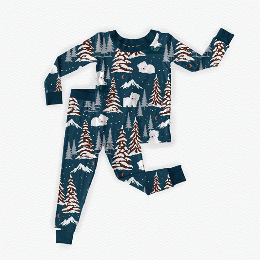 Blue bamboo kids pajamas featuring Benny the Bear in winter wonderland with braille label for visually impaired
